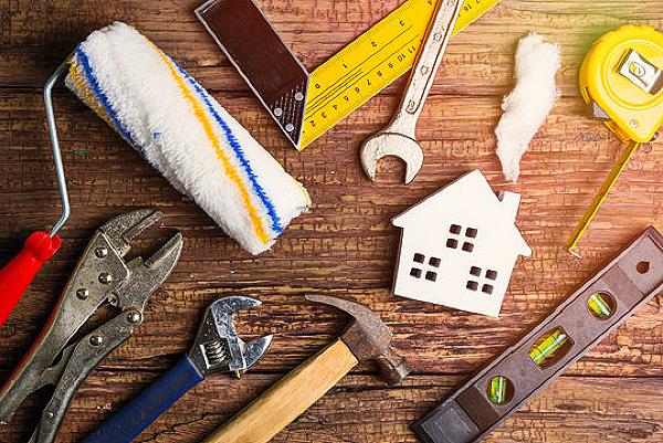 Homeowner reviewing a home maintenance checklist and budgeting for long-term property upkeep